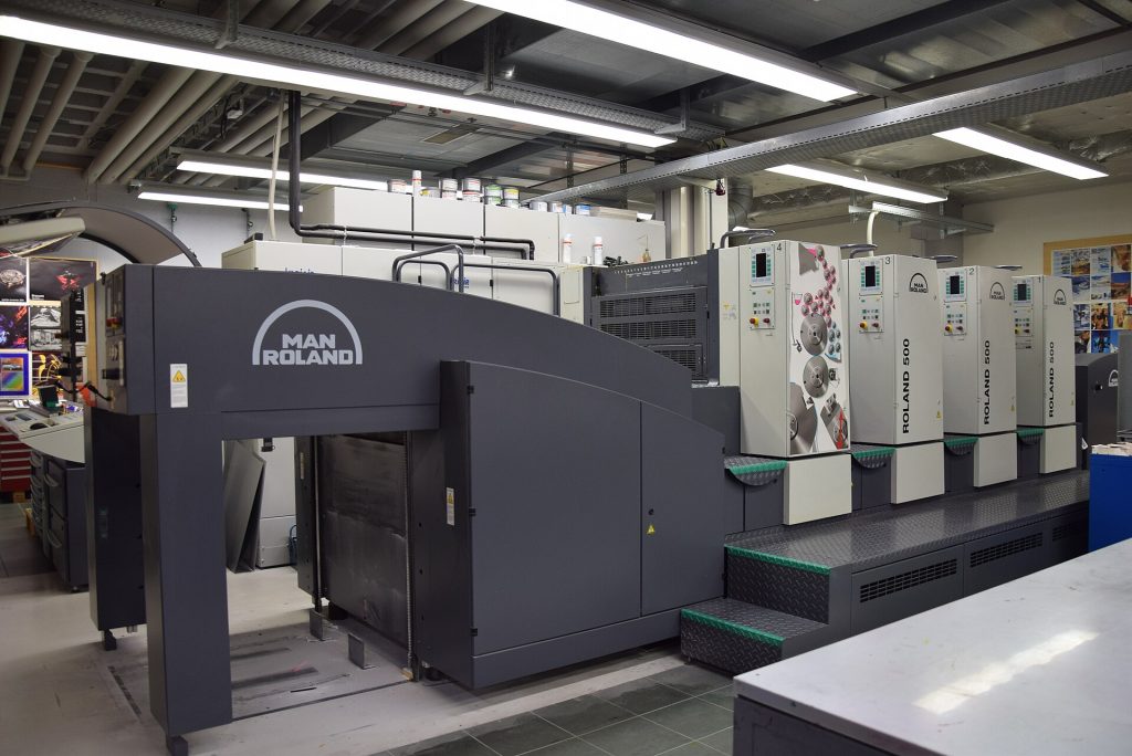 Modern four-colour sheetfed offset printing press in a print workshop