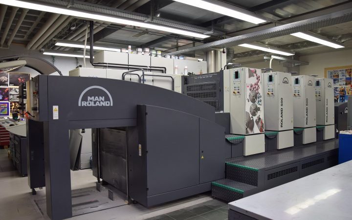 Modern four-colour sheetfed offset printing press in a print workshop
