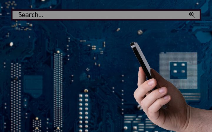 Hand holding a smartphone in front of a dark backdrop with a search bar overlay