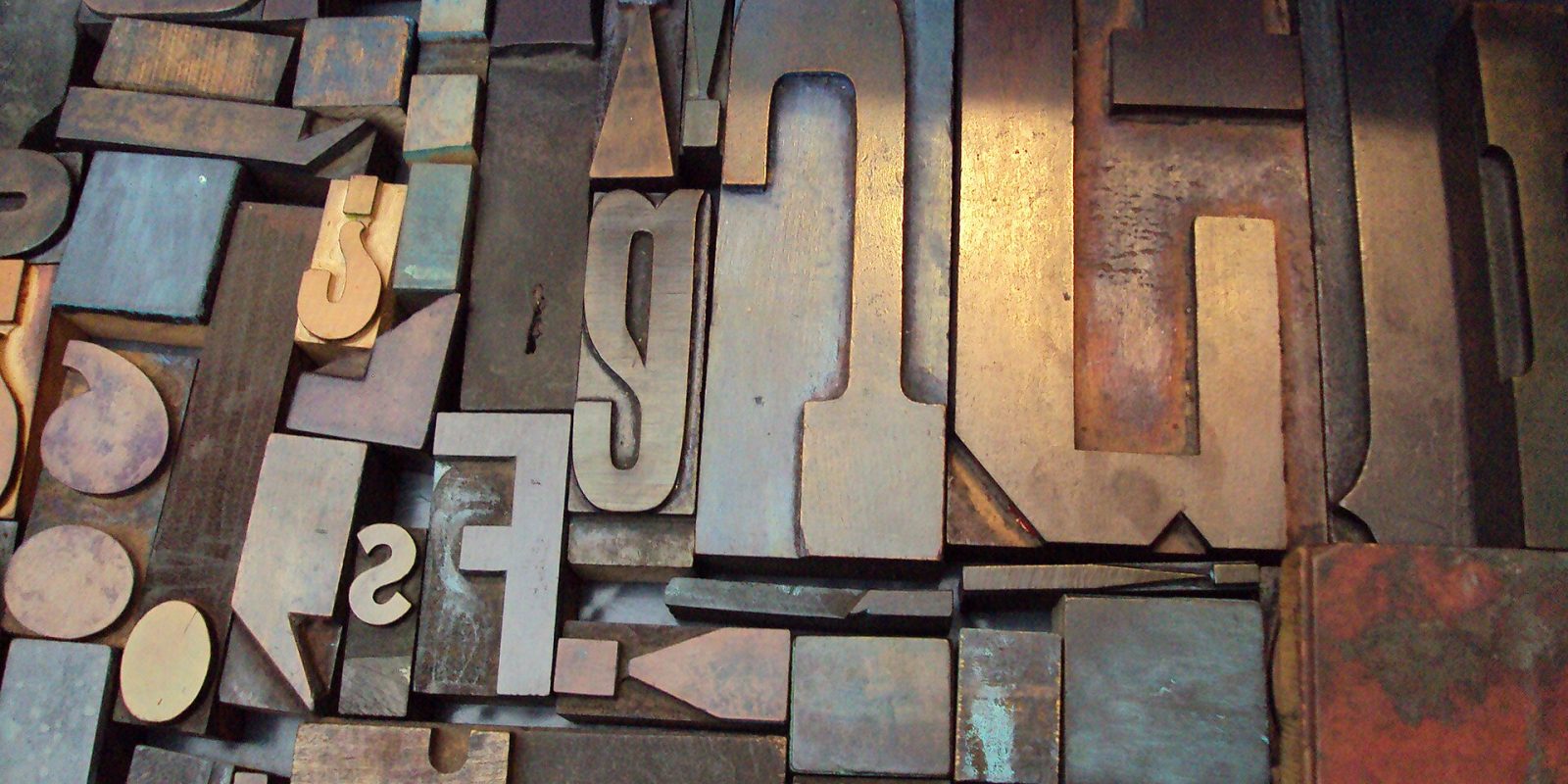 Assorted vintage wooden letterpress type blocks in different sizes and fonts