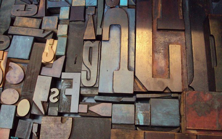 Assorted vintage wooden letterpress type blocks in different sizes and fonts