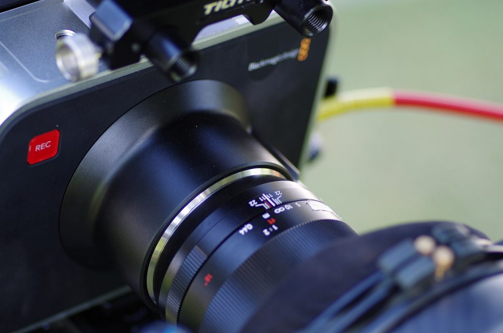 Close-up of a digital cinema camera with a large lens on a production rig