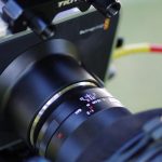 Close-up of a digital cinema camera with a large lens on a production rig