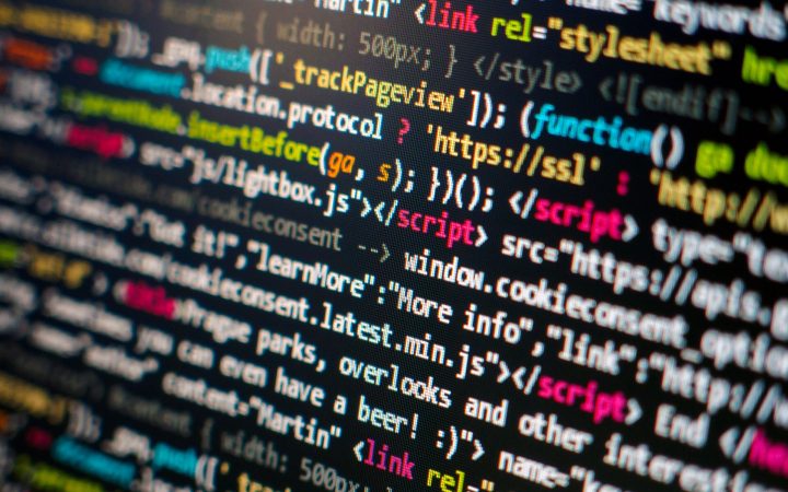 Close-up of colourful HTML and JavaScript source code on a computer screen