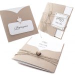 Rustic kraft-paper wedding invitation cards with twine and heart details on white