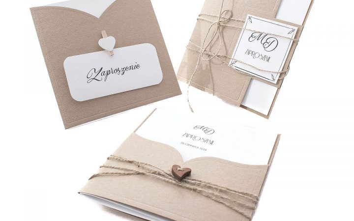 Rustic kraft-paper wedding invitation cards with twine and heart details on white